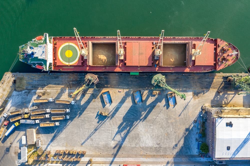 Top view from a drone of a large ship loading grain for export